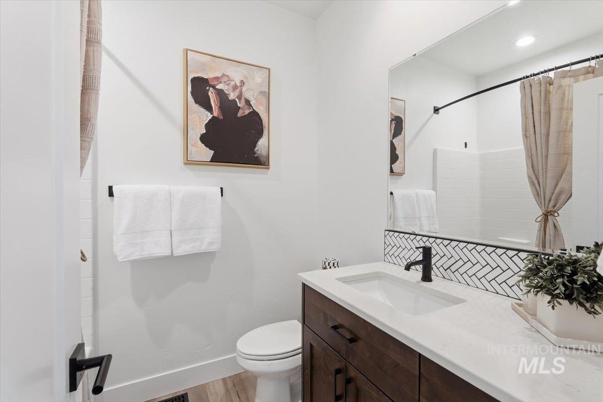 5897 West Riva Capri Street Meridian, ID 83646 - Photo 26 of 50 Bathroom featuring a dark wood-finish vanity with a white countertop and rectangular undermount sink