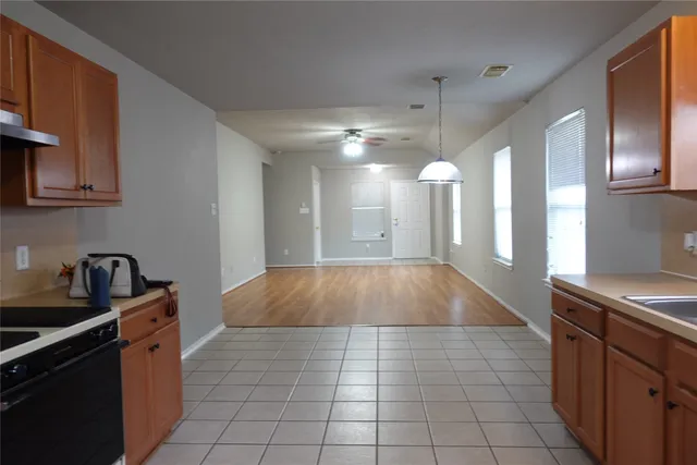 a kitchen with a sink a counter space appliances and cabinets