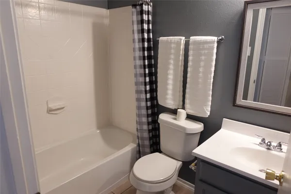 a white toilet sitting next to a bathroom sink
