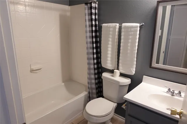 a white toilet sitting next to a bathroom sink