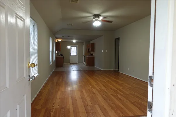 a view of a hallway with wooden floor