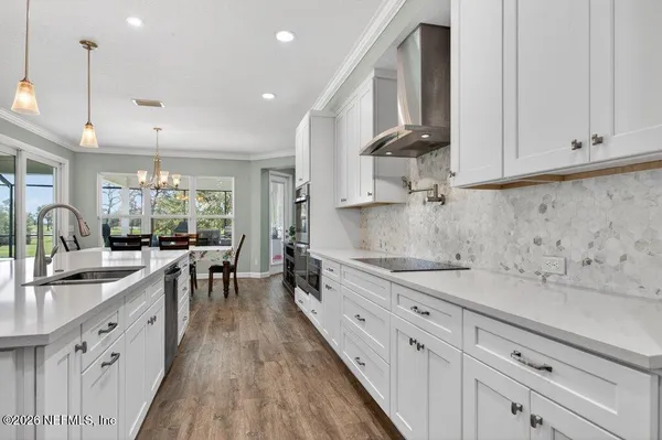 a kitchen with kitchen island white cabinets and refrigerator