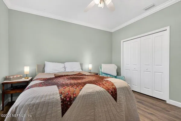 a bedroom with a bed and a chandelier
