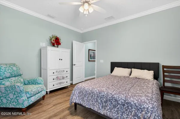 a bedroom with a bed and a large mirror