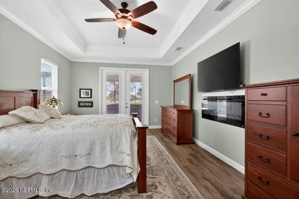 a view of a living room and floor to ceiling window and an outdoor kitchen