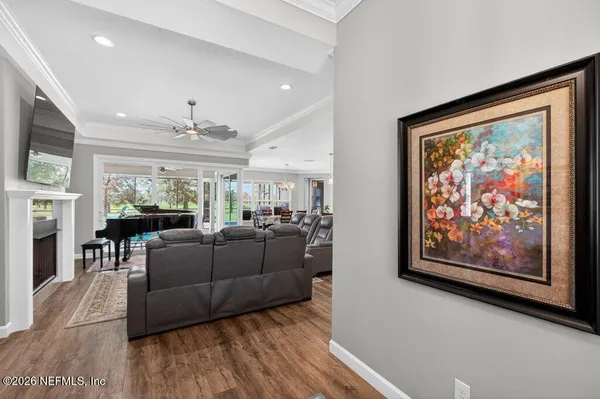 a living room with furniture a fireplace and a flat screen tv