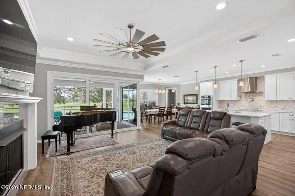 a living room with furniture and a chandelier