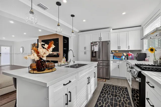 a kitchen with a sink stove and refrigerator