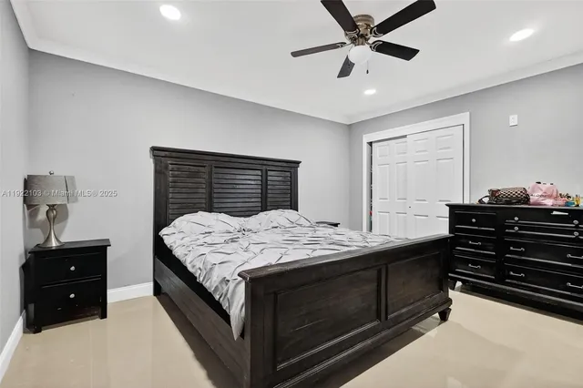a bedroom with a bed and a ceiling fan