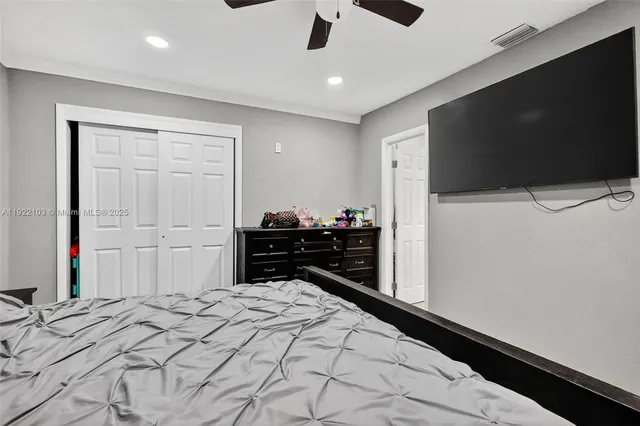 a bedroom with a bed and a flat screen tv