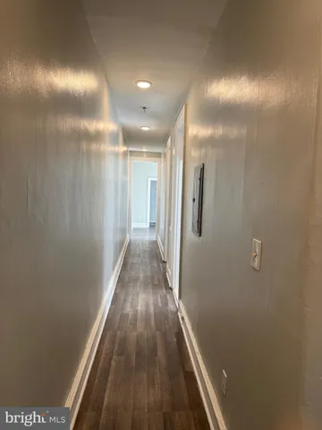 a view of hallway with wooden floor