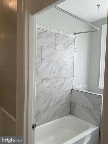 a bathroom with a shower and a bath tub