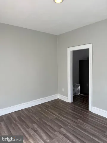 a view of an empty room and wooden floor