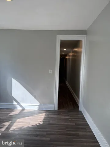 a view of hallway with wooden floor
