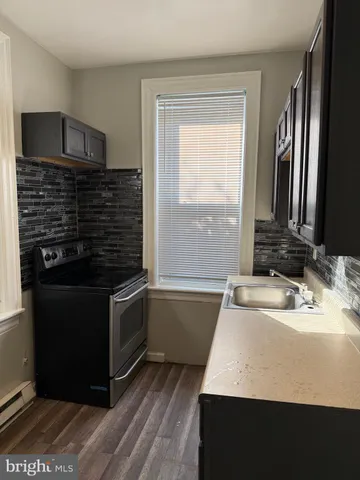 a kitchen with a sink and a stove top oven