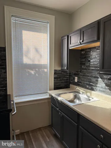 a bathroom with a sink and a window