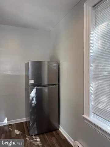 a metallic refrigerator freezer sitting in a kitchen