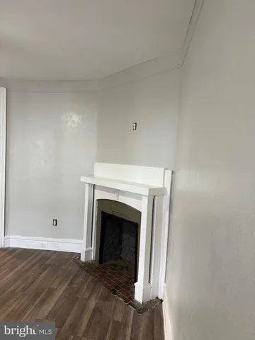 a view of empty room with a fireplace
