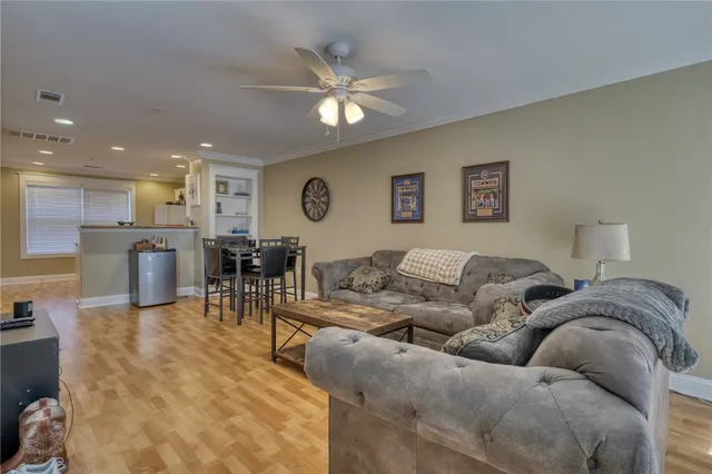 a living room with furniture and kitchen view