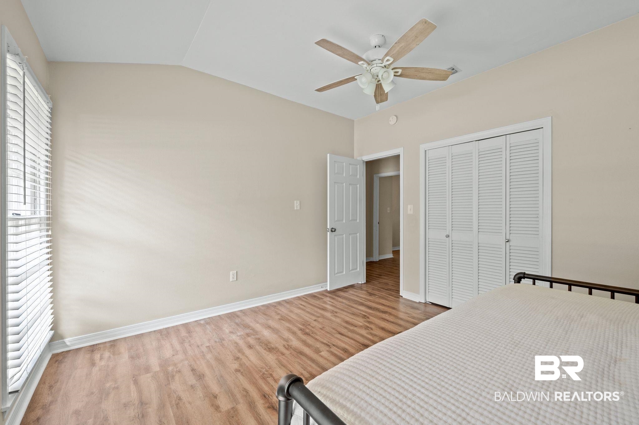 110 Ferncliff Circle Daphne, AL 36526 - Photo 26 of 40 Bedroom featuring wood finished floors, a closet, vaulted ceiling, baseboards, and ceiling fan