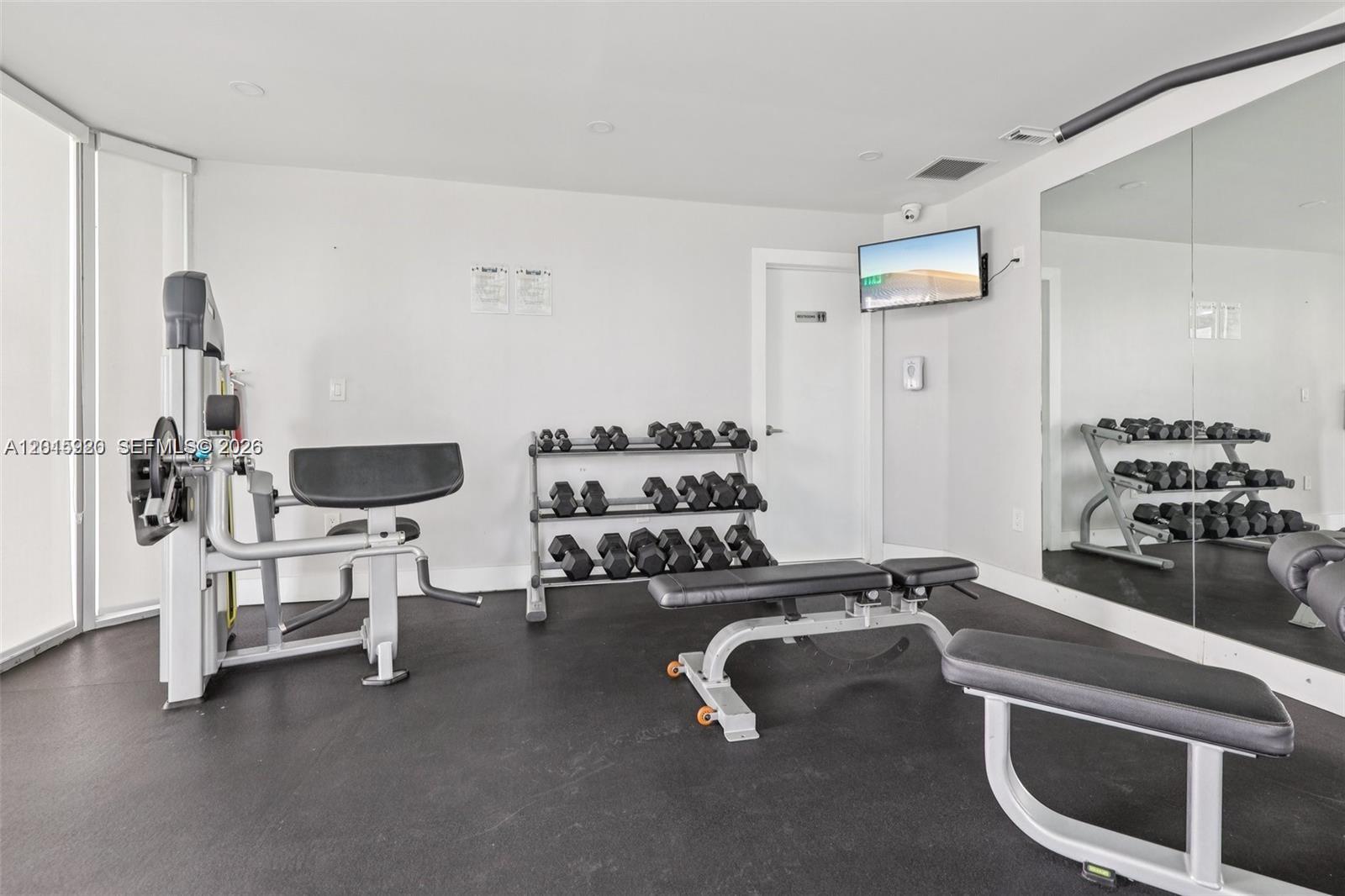 14170 Southwest 84th Street, Unit 404F Miami, FL 33183 - Photo 17 of 18 a room with gym equipment and a table