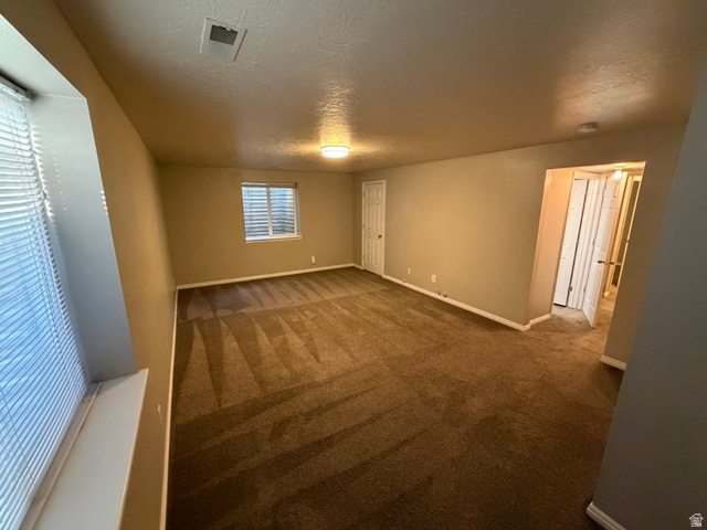 1563 South 600 East Springville, UT 84663 - Photo 21 of 30 Spacious room featuring neutral carpeting, a single window with horizontal blinds, and a built-in ceiling light fixture