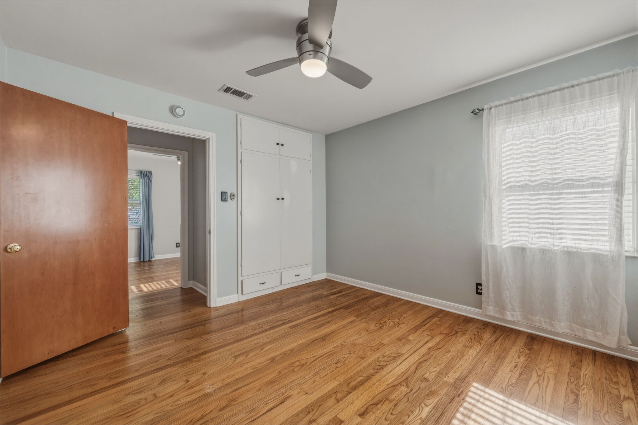 1908 Cullen Avenue Austin, TX 78757 - Photo 11 of 40 a view of an empty room with wooden floor and a window