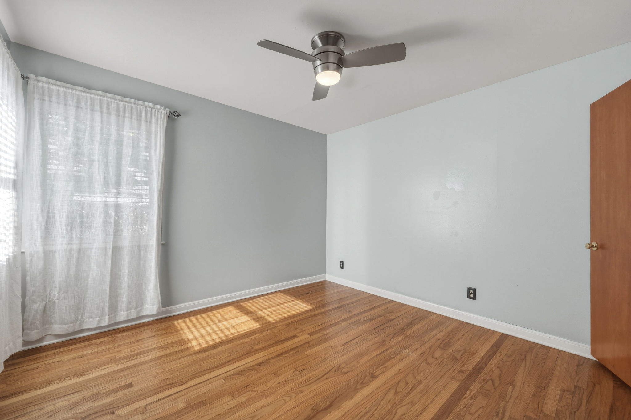 1908 Cullen Avenue Austin, TX 78757 - Photo 12 of 40 an empty room with wooden floor fan and windows