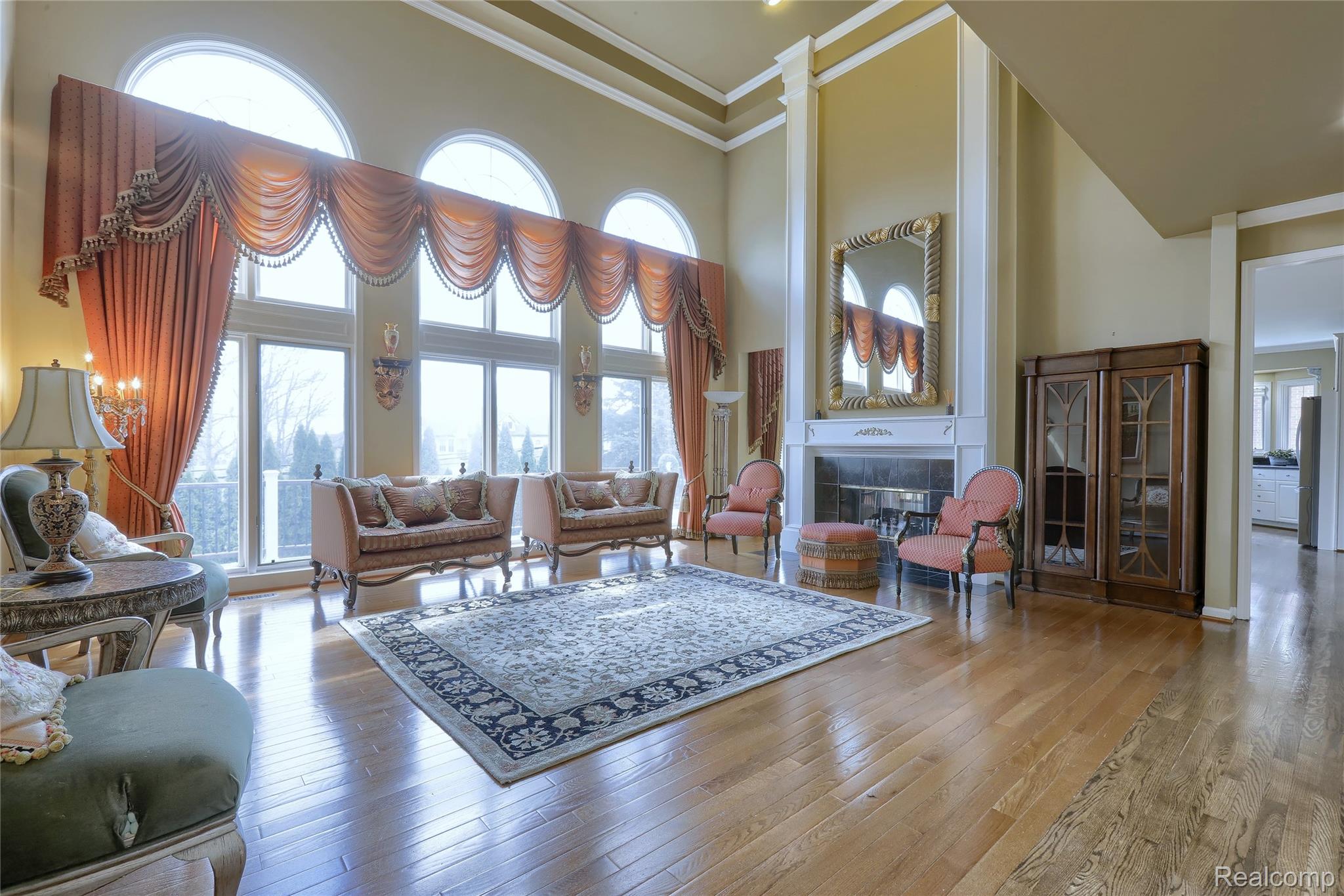 2007 Mapleridge Road Rochester, MI 48309 - Photo 11 of 45 Living area with a fireplace, a high ceiling, hardwood / wood-style floors, and ornamental molding