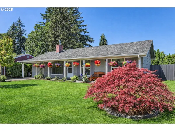 a front view of a house with a garden