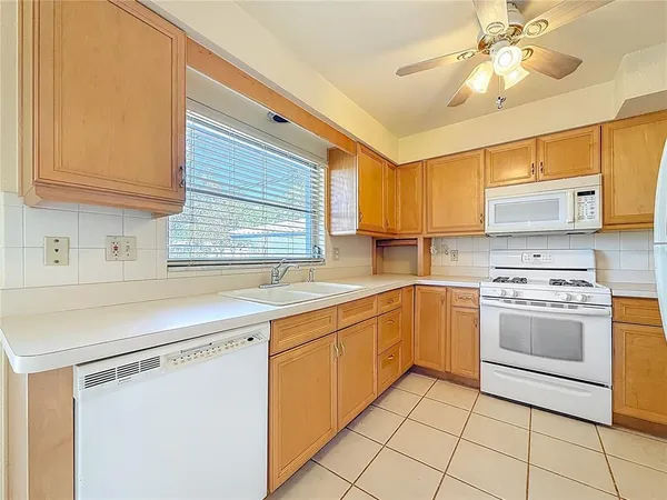a kitchen with a stove cabinets and window