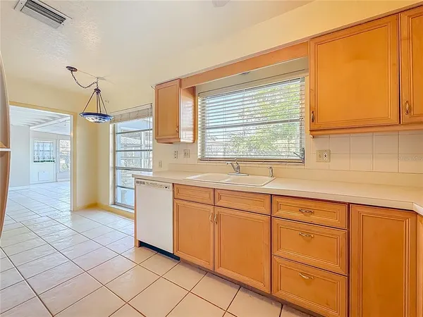 a kitchen with cabinets and window