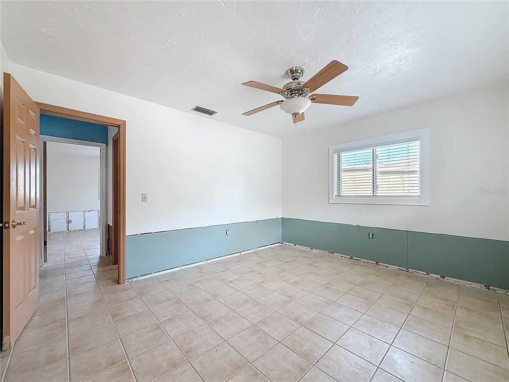 4869 Shell Stream Boulevard New Port Richey, FL 34652 - Photo 25 of 46 a view of a livingroom with a ceiling fan and window