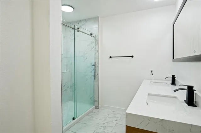 a bathroom with a sink and shower