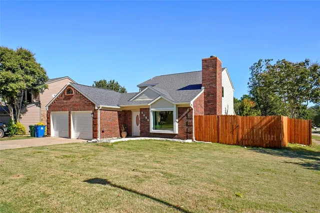 a front view of a house with a garden and yard