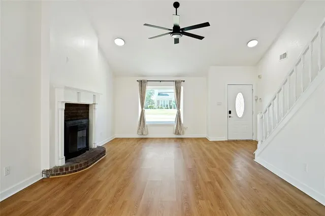 wooden floor in an empty room with a window
