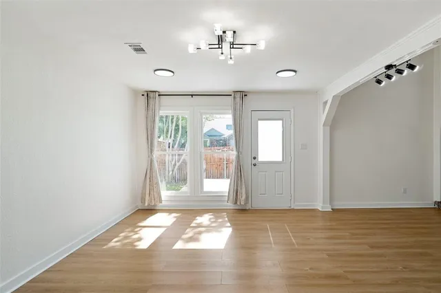 wooden floor in an empty room with a window