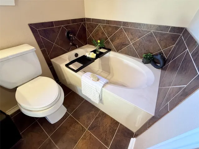 a bathroom with a sink mirror and toilet