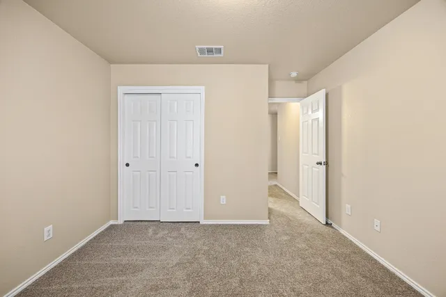 a view of backyard of house and trees