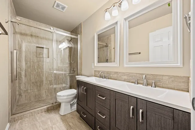 a front view of a house with a garden and yard