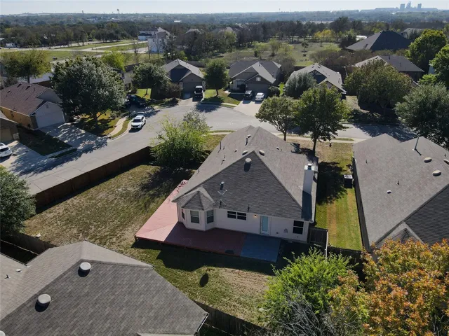 an aerial view of multiple houses with yard