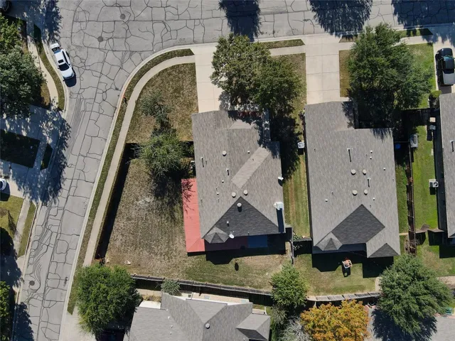 an aerial view of a residential houses with outdoor space
