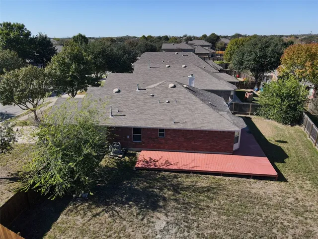 an aerial view of a house with a yard