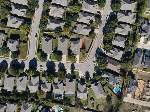 an aerial view of a house with a yard basket ball court and outdoor seating