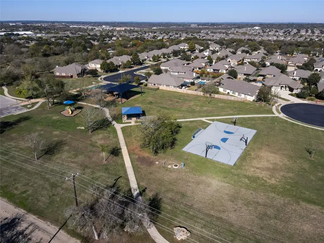 an aerial view of a house with a yard