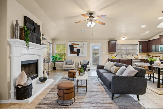 a living room with furniture a fireplace and a flat screen tv
