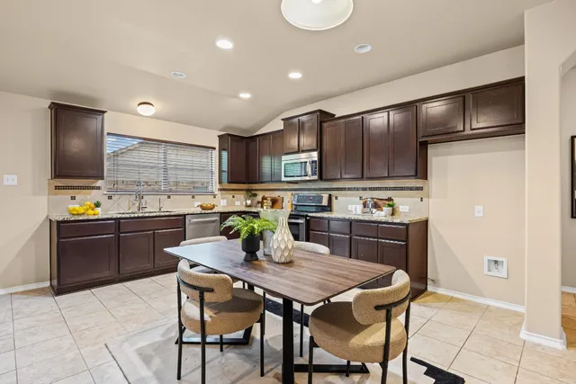 a kitchen with a refrigerator a stove top oven and a center island