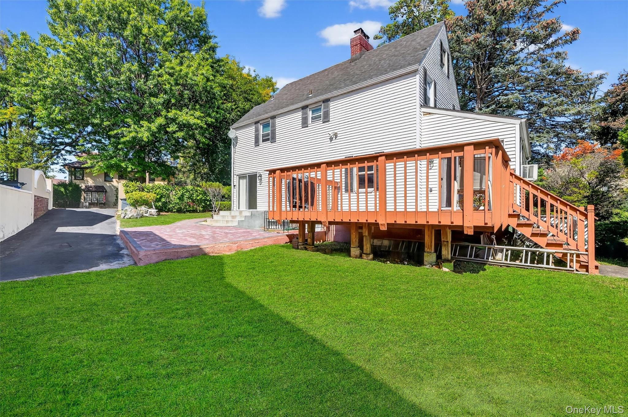 3384 Country Club Road Bronx, NY 10465 - Photo 38 of 48 Back of house with a lawn, a chimney, a shingled roof, and a wooden deck