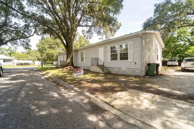 a backyard of a house with yard and outdoor seating