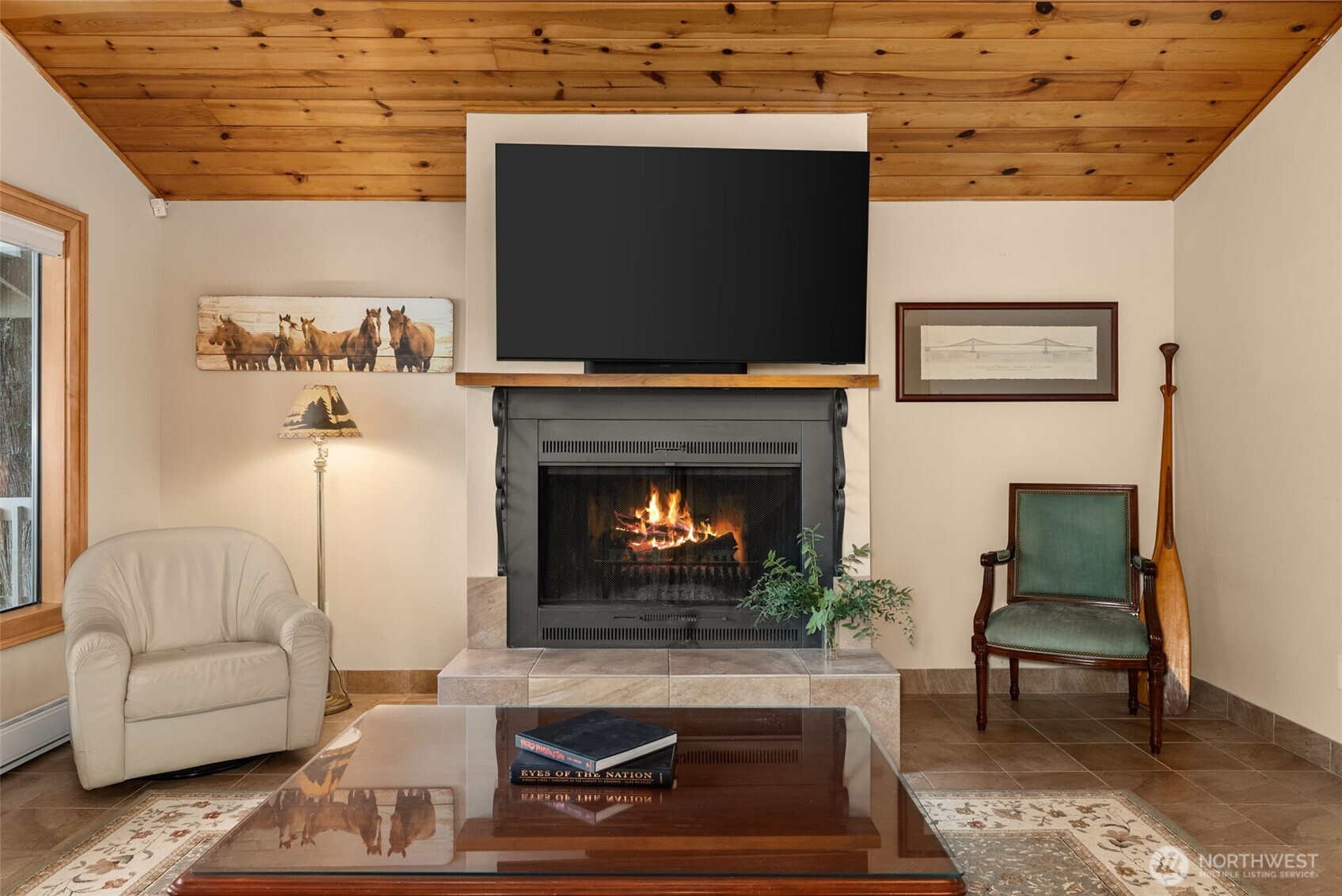 2147 Summit Lake Shore Road Northwest Olympia, WA 98502 - Photo 13 of 38 a living room with furniture a flat screen tv and a fireplace